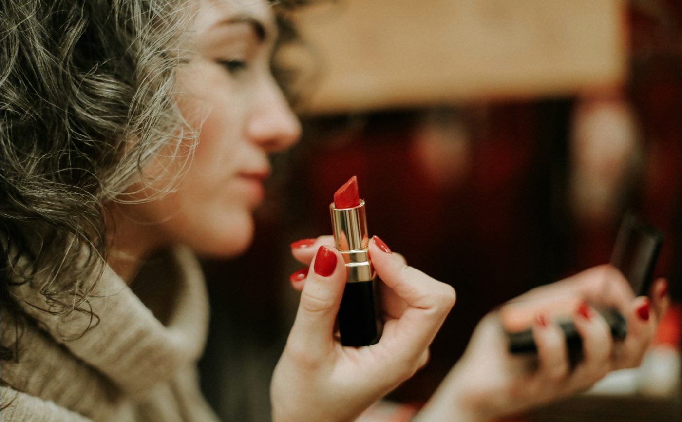 a woman putting on makeup